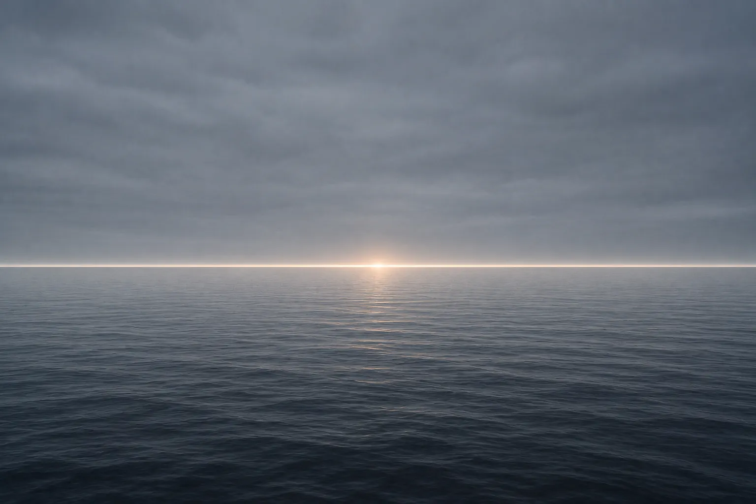 A calm sea meeting a flat grey sky, a single thin band of light marking the horizon