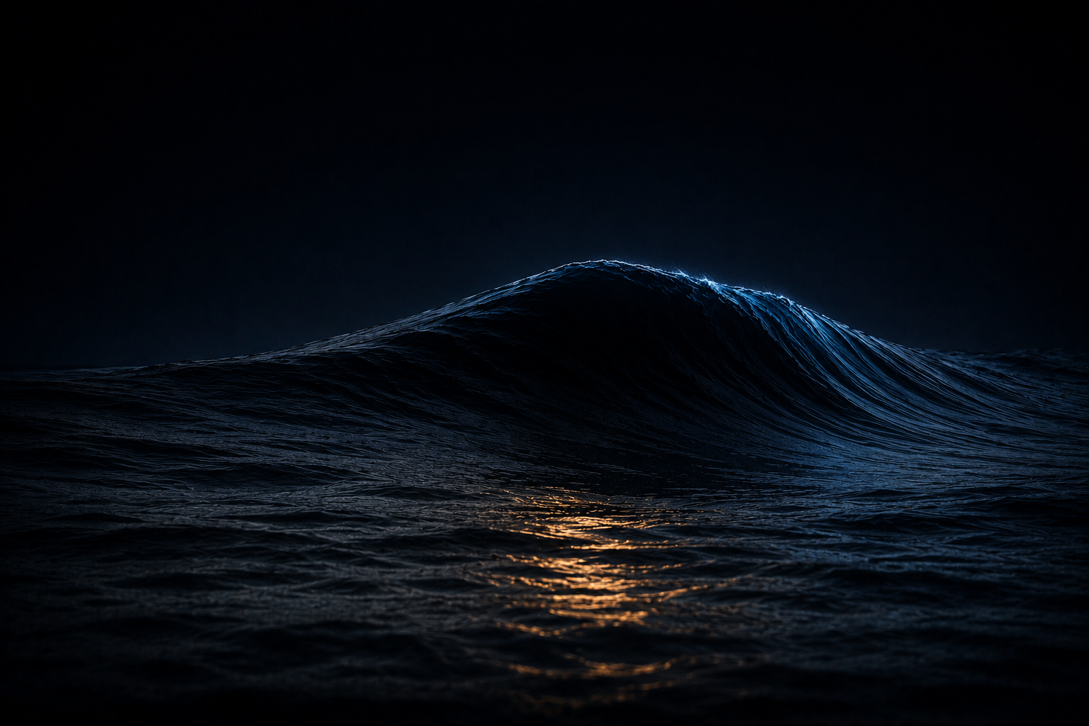 A single large smooth swell rising on a dark night ocean, one warm reflection at its base