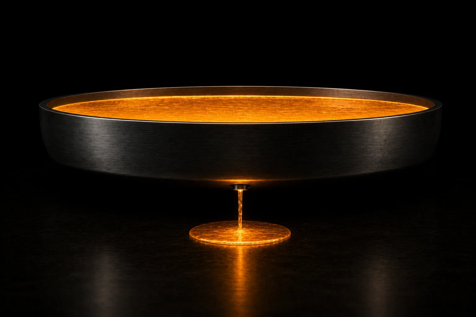 A shallow steel basin still full of glowing liquid, with one thin stream draining from its underside into a small pool.