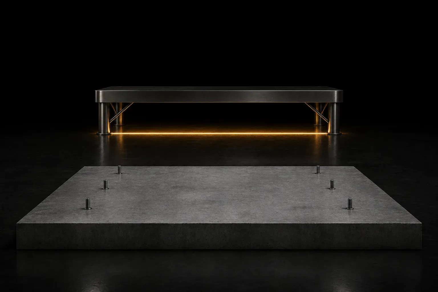 An empty concrete foundation with short cut anchor bolts, and behind it an intact steel platform glowing warm along its underside.